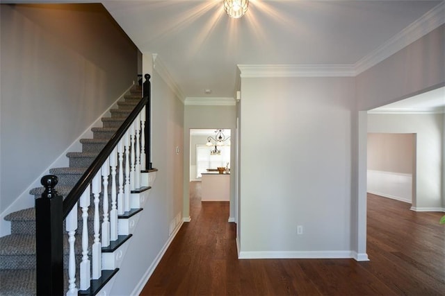 hallway featuring stairway, a notable chandelier, crown molding, and wood finished floors
