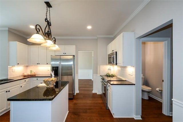 kitchen with crown molding, appliances with stainless steel finishes, backsplash, and white cabinets