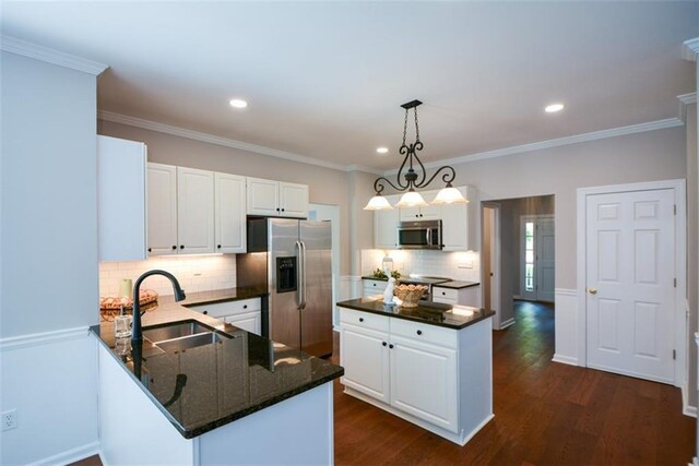 kitchen featuring a sink, tasteful backsplash, appliances with stainless steel finishes, and white cabinets