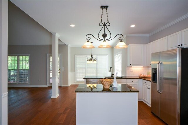 kitchen featuring white cabinets, stainless steel refrigerator with ice dispenser, a chandelier, and a healthy amount of sunlight