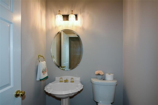 half bath with a sink and toilet