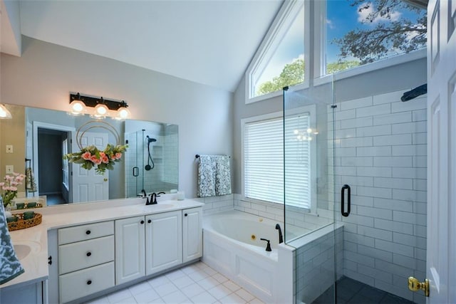 bathroom featuring tile patterned flooring, double vanity, a garden tub, and a stall shower