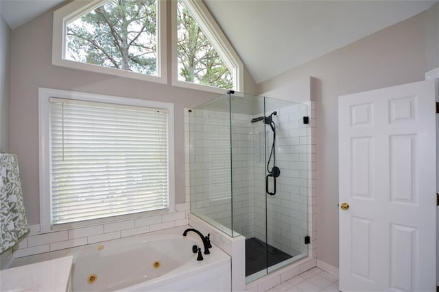 bathroom with a shower stall, plenty of natural light, a tub with jets, and vaulted ceiling
