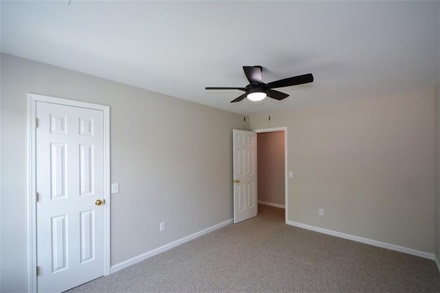 unfurnished bedroom featuring carpet, baseboards, and a ceiling fan