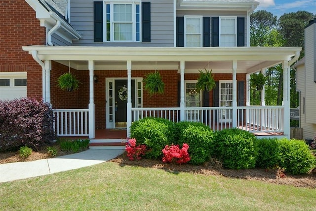 property entrance featuring brick siding and covered porch