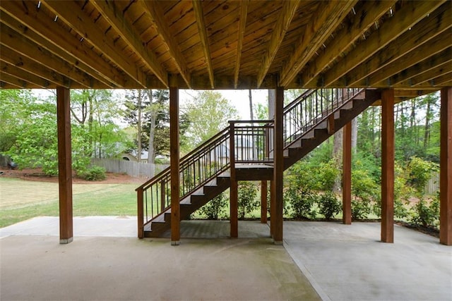 view of patio with fence and stairway