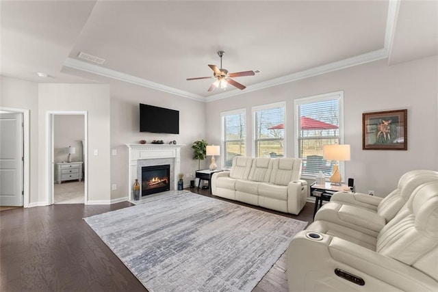 living room featuring ceiling fan, ornamental molding, and hardwood / wood-style floors