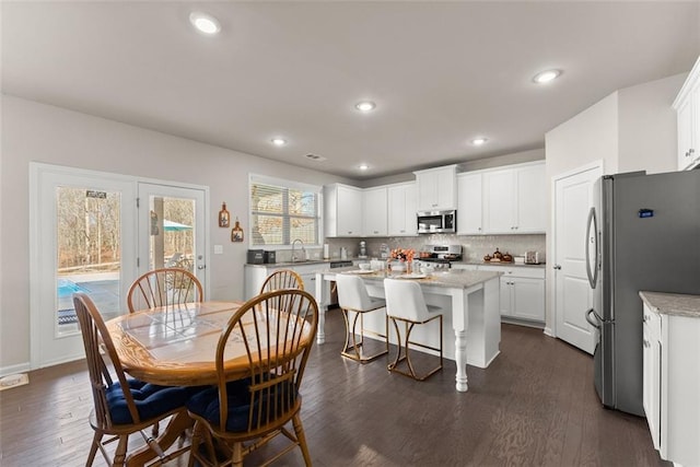 dining room featuring dark wood-type flooring and sink