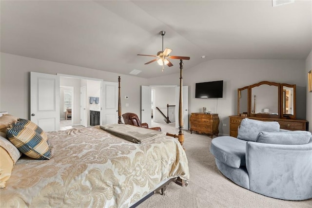 bedroom featuring ceiling fan, vaulted ceiling, and light carpet