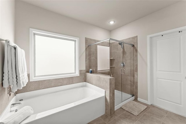 bathroom with tile patterned flooring and shower with separate bathtub