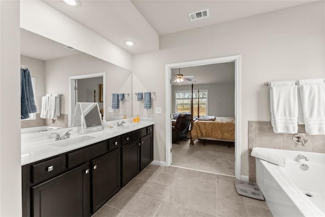 bathroom with vanity, a tub to relax in, tile patterned flooring, and ceiling fan