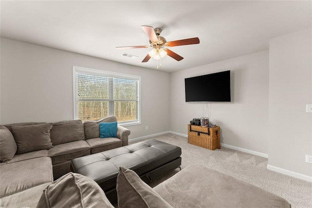 carpeted living room with ceiling fan