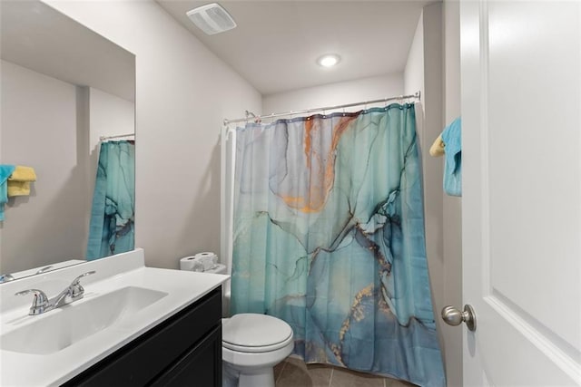 bathroom with vanity, tile patterned floors, and toilet