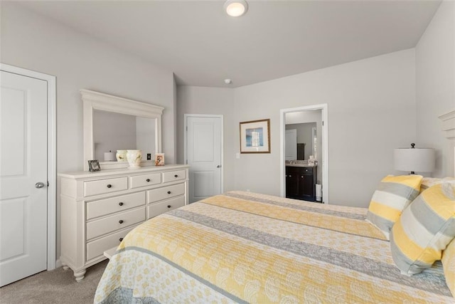 bedroom featuring ensuite bath and light carpet