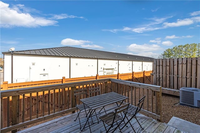 wooden terrace featuring central AC and fence