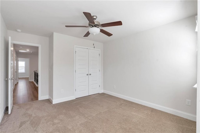 unfurnished bedroom with carpet flooring and baseboards