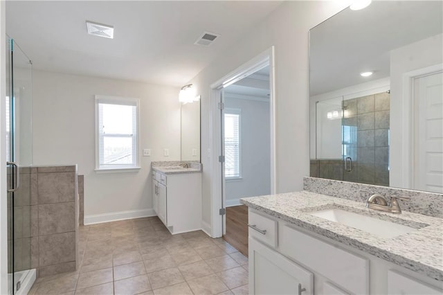 bathroom with a wealth of natural light, visible vents, a sink, and a shower stall