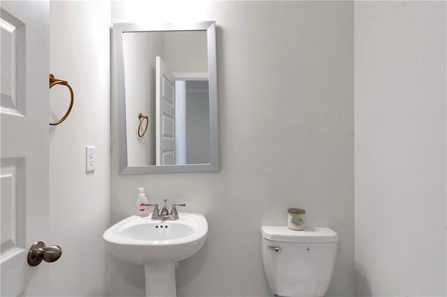 half bath with a sink and toilet