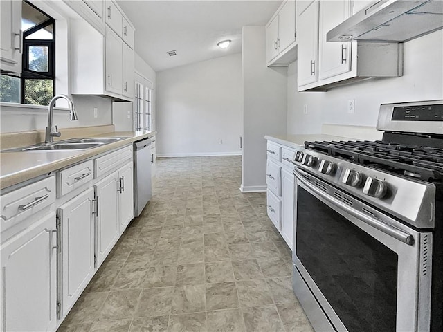 kitchen featuring white cabinets, appliances with stainless steel finishes, sink, and vaulted ceiling