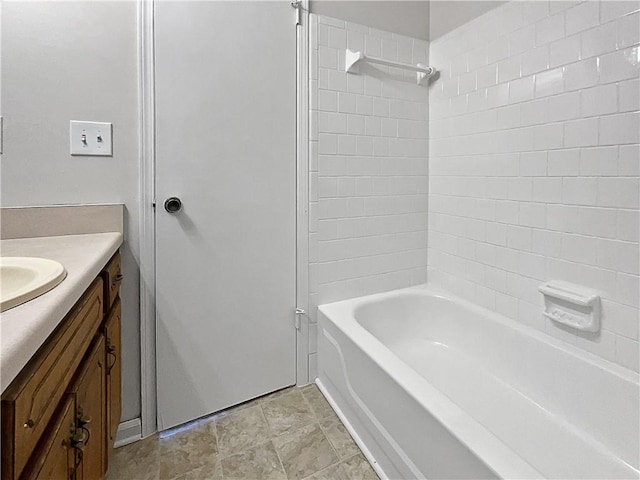 bathroom with vanity and tiled shower / bath combo