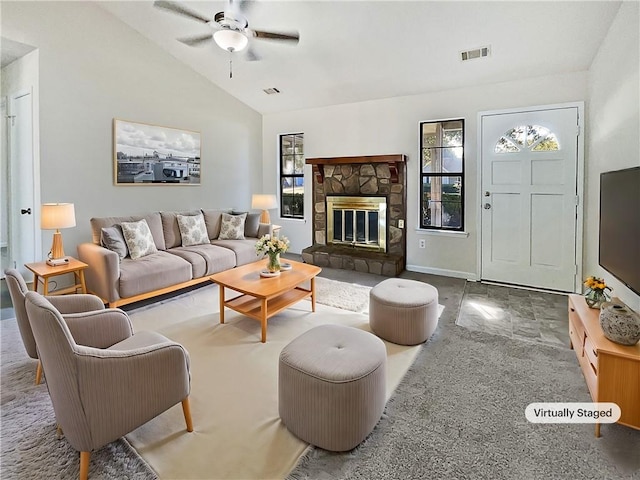 living room featuring lofted ceiling, a fireplace, and ceiling fan