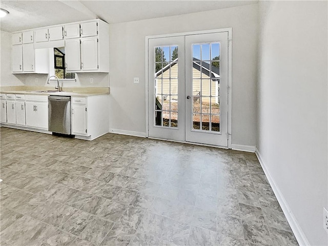 kitchen featuring french doors, sink, stainless steel dishwasher, and white cabinetry