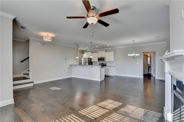 unfurnished living room with crown molding, dark hardwood / wood-style floors, and ceiling fan with notable chandelier