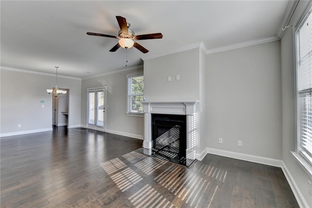 unfurnished living room featuring ceiling fan with notable chandelier, dark hardwood / wood-style floors, and crown molding