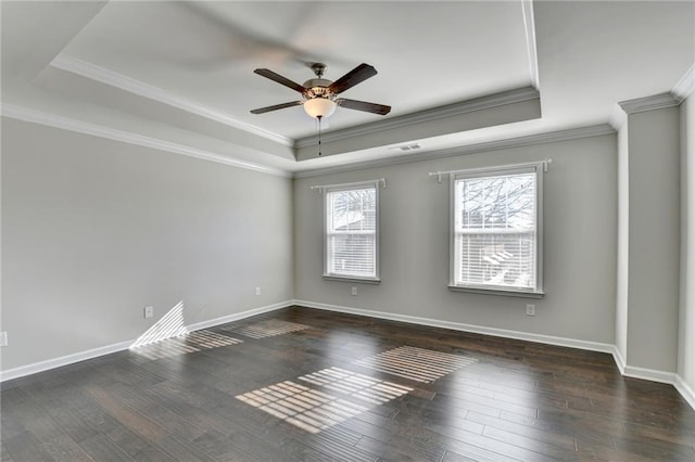 empty room featuring a tray ceiling, ceiling fan, and dark hardwood / wood-style floors