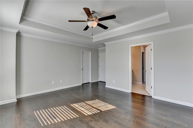 unfurnished room with ceiling fan, a raised ceiling, and ornamental molding