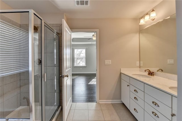 bathroom featuring tile patterned flooring, vanity, ceiling fan, and a shower with shower door