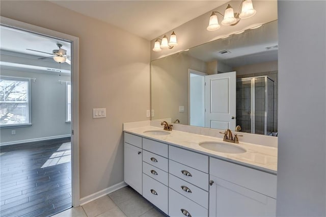 bathroom with ceiling fan, vanity, and walk in shower