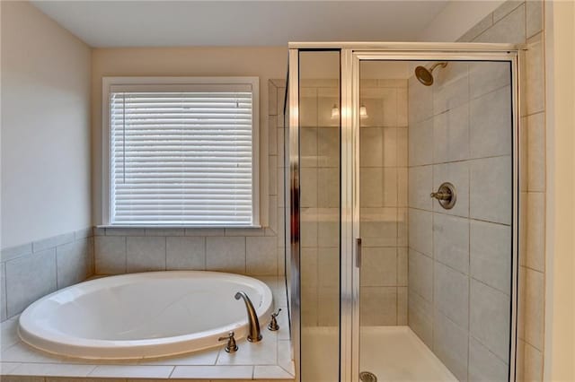 bathroom featuring independent shower and bath