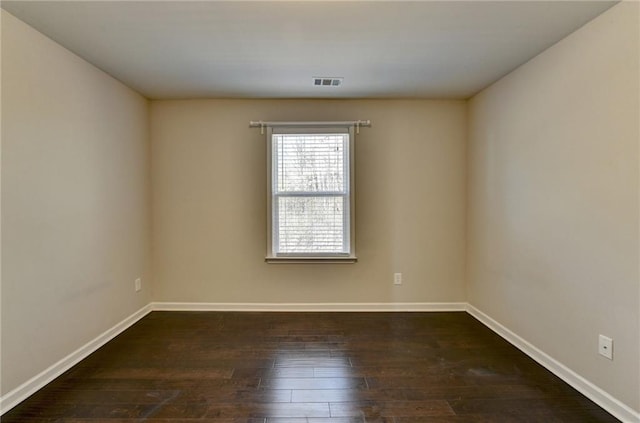 unfurnished room featuring dark hardwood / wood-style flooring