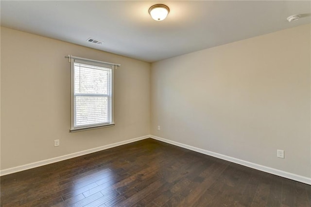 unfurnished room featuring dark hardwood / wood-style floors