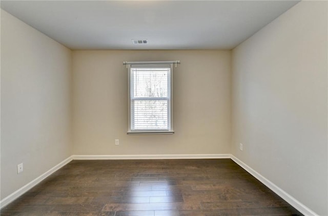 unfurnished room with dark hardwood / wood-style flooring