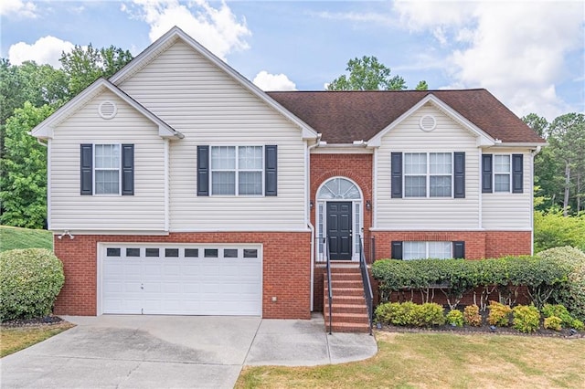 bi-level home featuring a front lawn and a garage