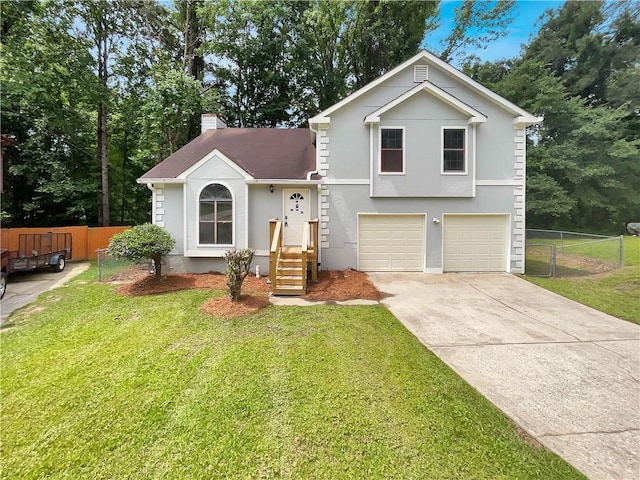 320 Rebecca Lake Way, Fairburn, GA 30213 - tri-level home with an attached garage, driveway, a chimney, and stucco siding