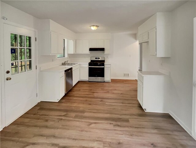 320 Rebecca Lake Way, Fairburn, GA 30213 - kitchen featuring appliances with stainless steel finishes, under cabinet range hood, white cabinetry, and a sink