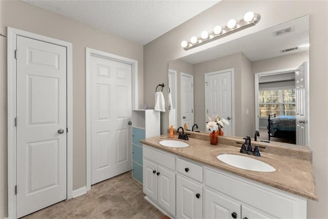 bathroom featuring vanity and a textured ceiling