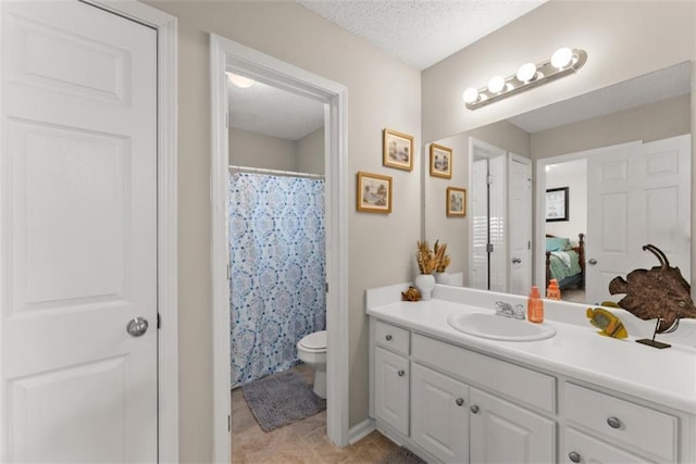 bathroom featuring tile patterned floors, toilet, a textured ceiling, vanity, and a shower with shower curtain