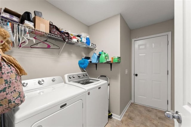 clothes washing area with light tile patterned floors and independent washer and dryer