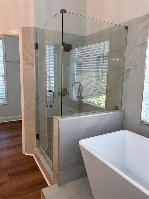 3850 Laurel Dr NW, Acworth, GA 30101 - bathroom featuring a stall shower, wood finished floors, a soaking tub, and plenty of natural light