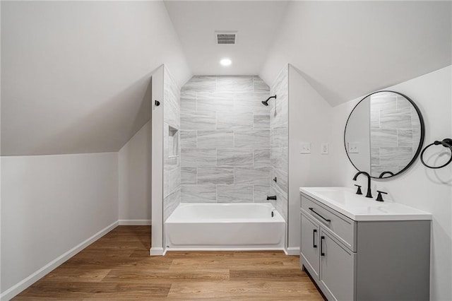 3850 Laurel Dr NW, Acworth, GA 30101 - full bath with lofted ceiling, vanity, tub / shower combination, and wood finished floors