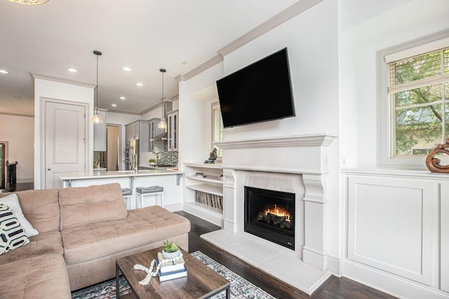 1216 Virginia Ct NE Unit 8, Atlanta, GA 30306 - living room featuring a warm lit fireplace, dark wood-type flooring, crown molding, and recessed lighting