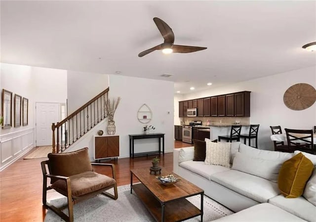 6038 Mayfield Way SE, Mableton, GA 30126 - living room with a ceiling fan, stairs, and light wood-style flooring