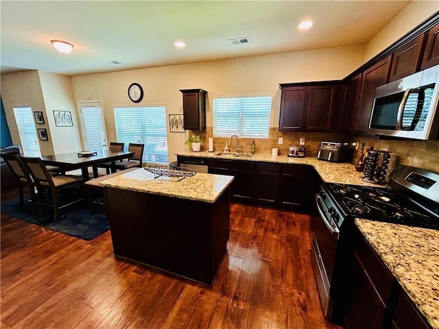 5848 Rex Ridge Loop, Rex, GA 30273 - kitchen with appliances with stainless steel finishes, a sink, a center island, dark wood-style floors, and decorative backsplash