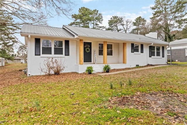 single story home with metal roof, a porch, a front lawn, and a chimney