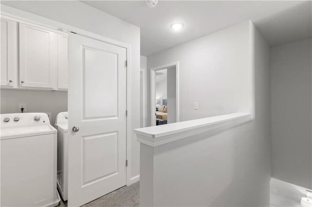 clothes washing area featuring washing machine and clothes dryer and light colored carpet