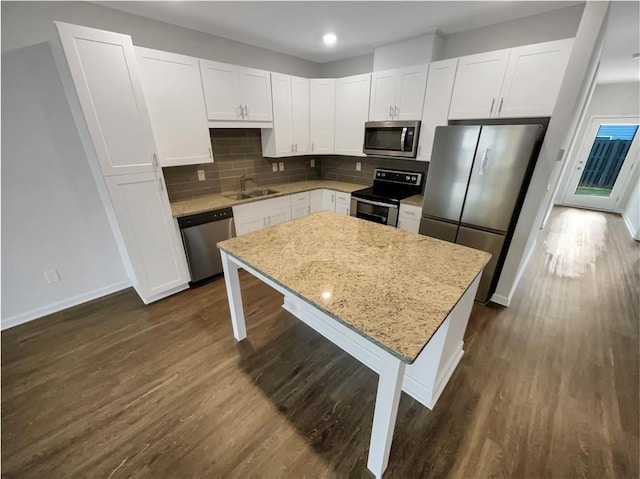 kitchen featuring white cabinetry, a kitchen island, and stainless steel appliances